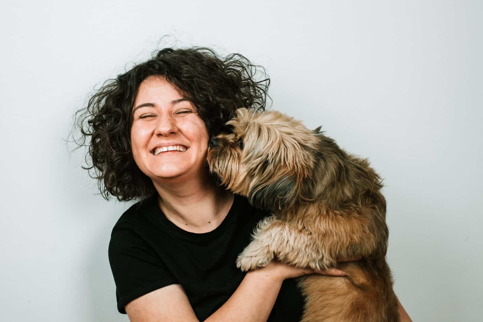 A woman and her dog show affection.